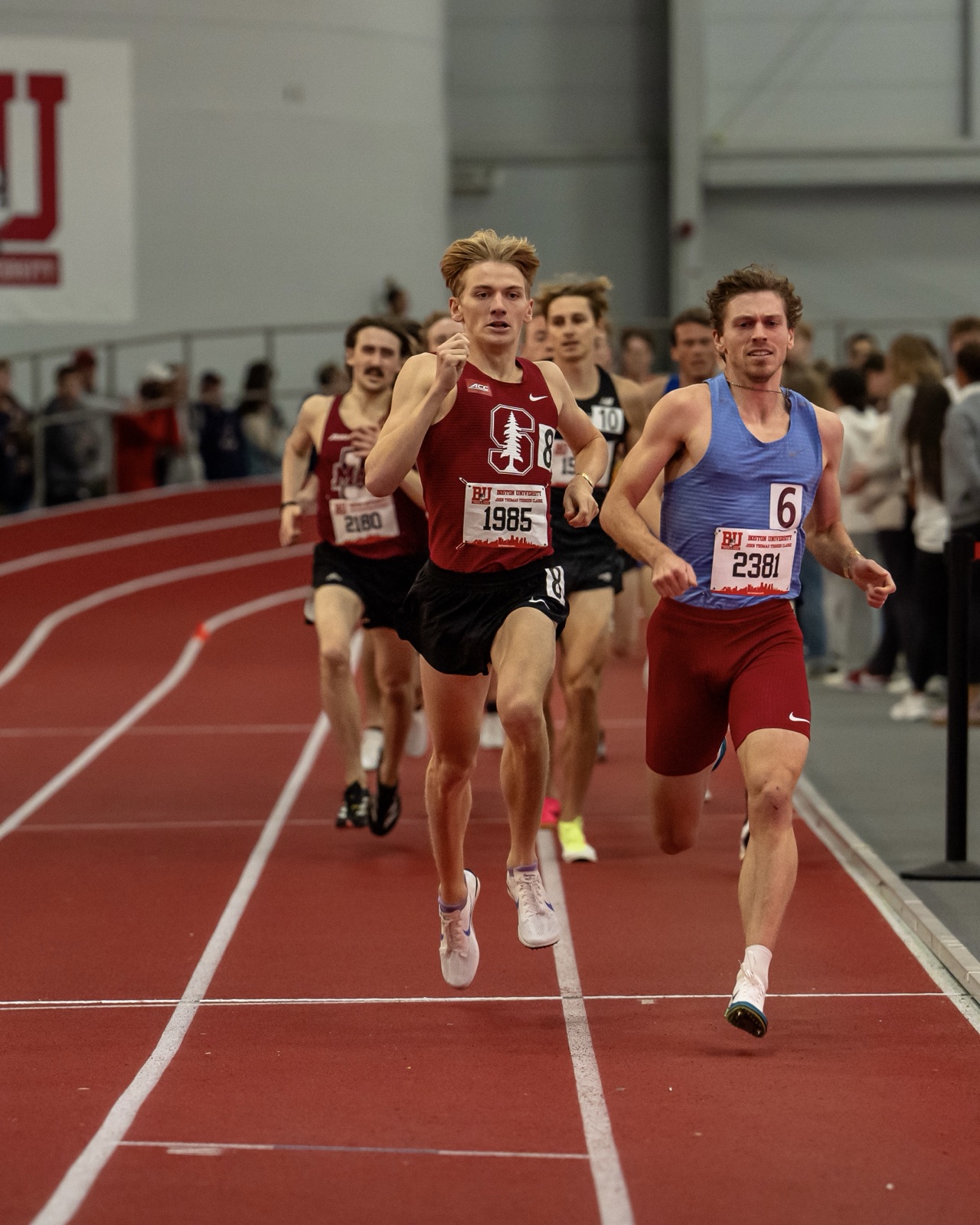 Zane leading the pack off the final bend at the Boston University indoor track